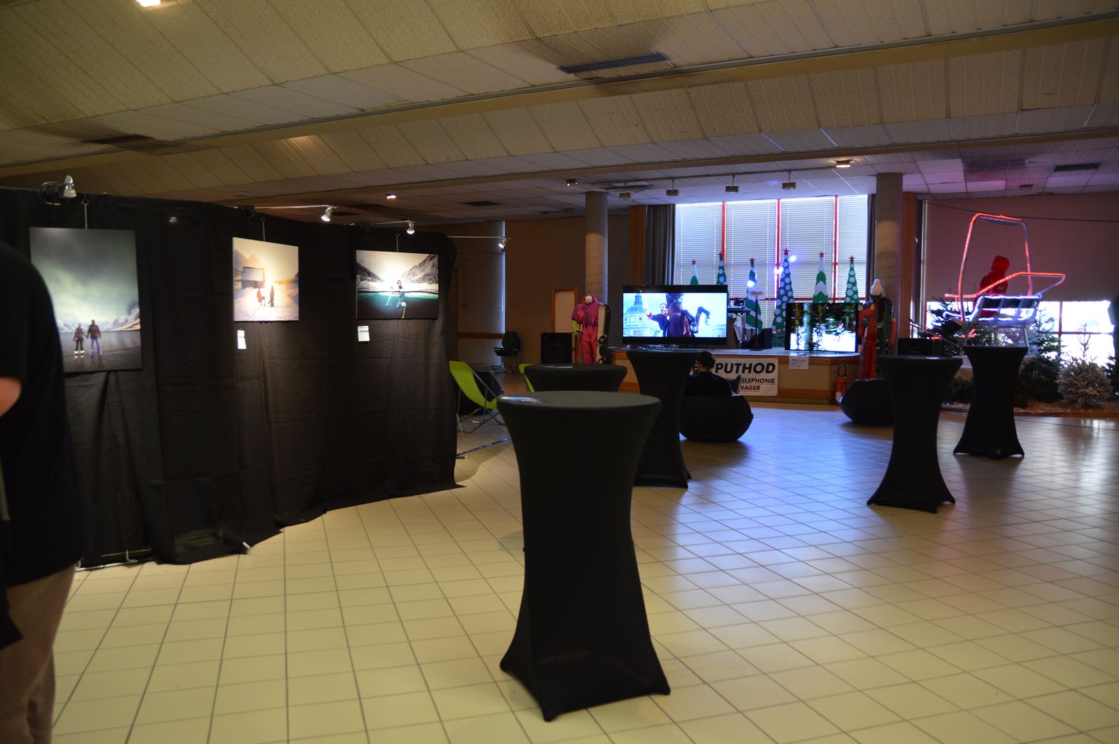 The festival hall with its screens and photo walls.